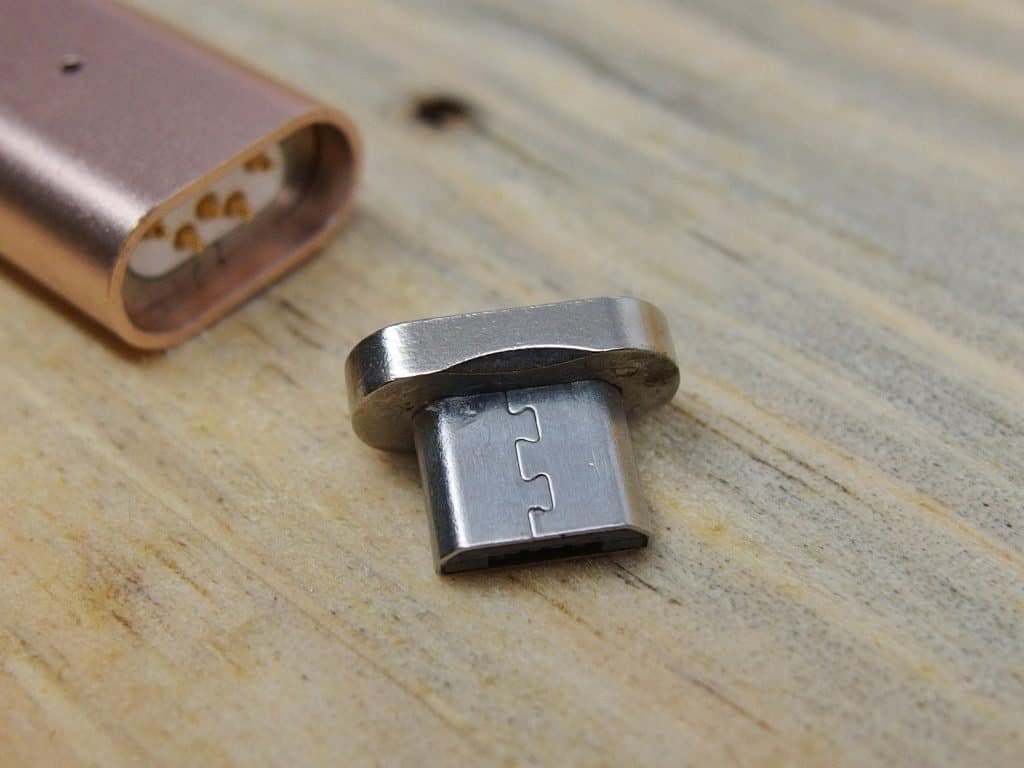 A micro usb adapter made from injection molding materials on a wooden table.