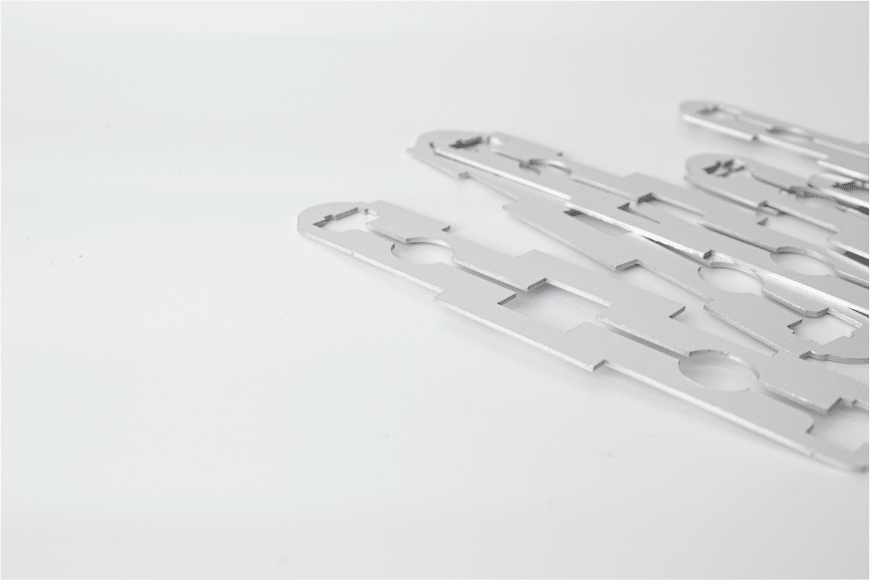 A group of metal pieces on a white surface.