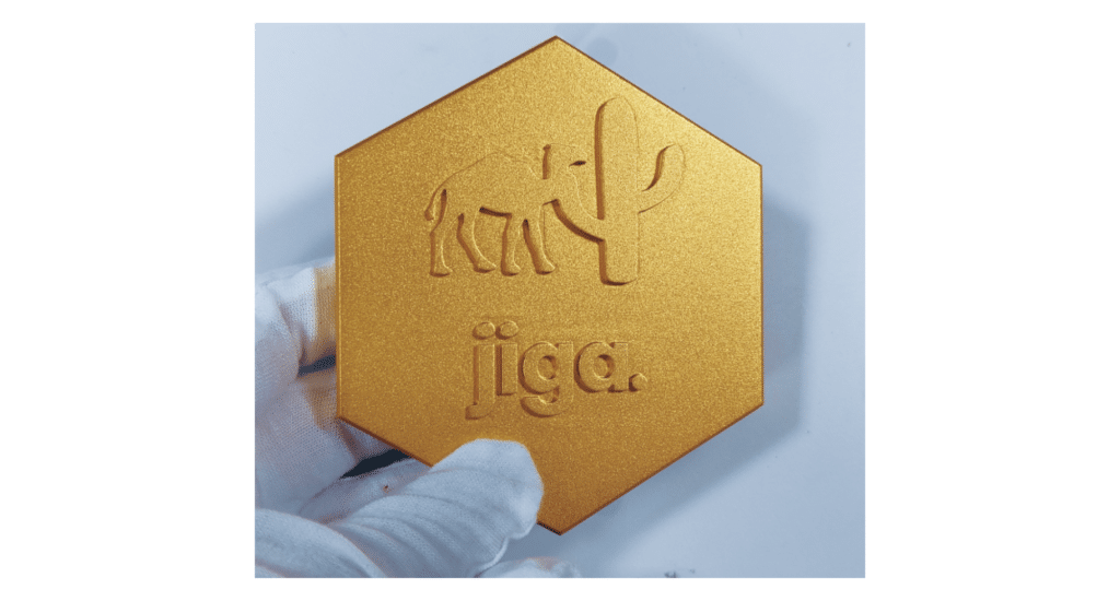 Gold-colored hexagonal aluminum part likely treated with anodizing or alodining. Illustrates the surface finish quality and corrosion-resistant coating achieved through surface treatment processes.