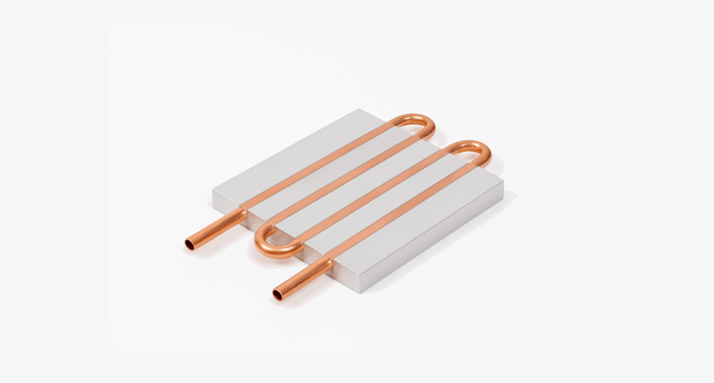 A copper heat pipe is embedded in a rectangular aluminum block, with two straight copper tube ends protruding from opposite sides—an example of what is a cold plate used for thermal management.