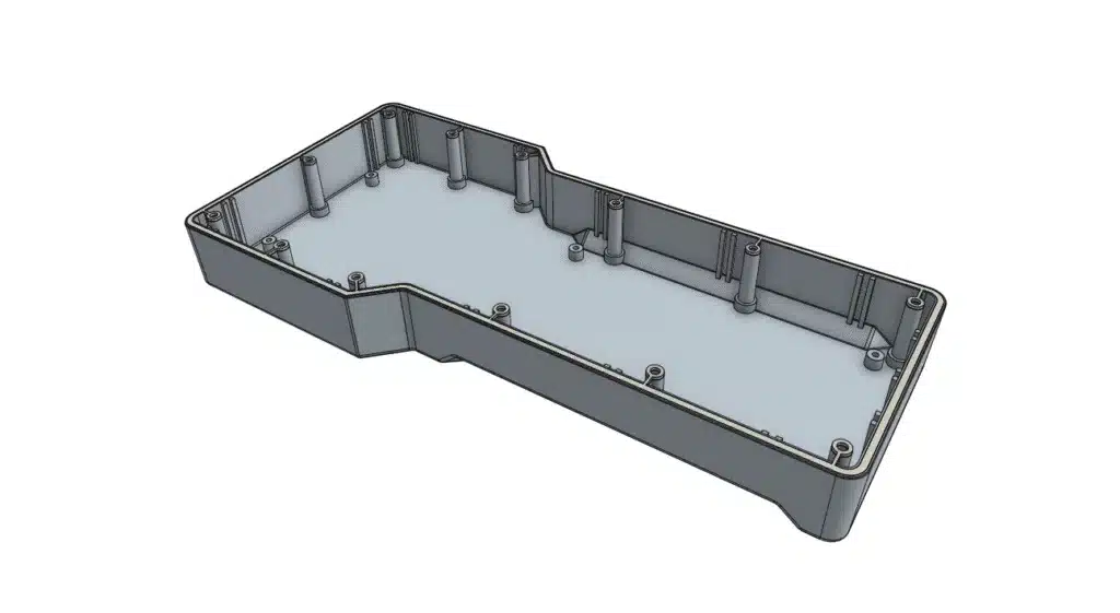Rectangular gray plastic enclosure with multiple screw posts and a raised edge, viewed from an angled top perspective.