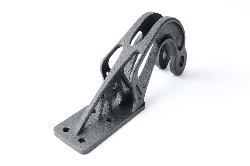A black piece of metal on a white background printed on SLM 3d printer
