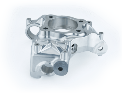 An aluminum engine block on a white background.